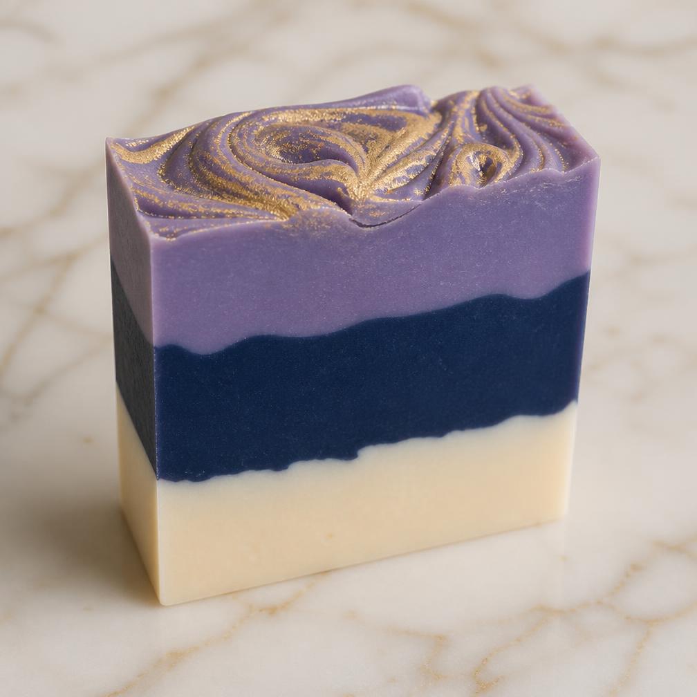 Close-up of a three-layer cold process soap bar with gold mica swirl